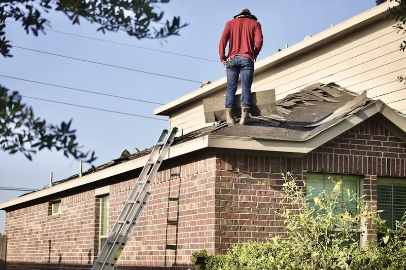 Professional roofer working on a residential roof in Langhorne